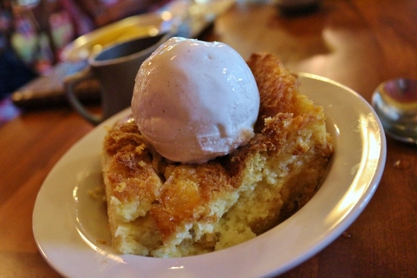 a square of bread pudding topped with ice cream