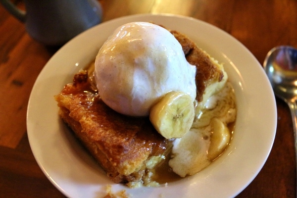 bread pudding topped with ice cream and a banana caramel sauce