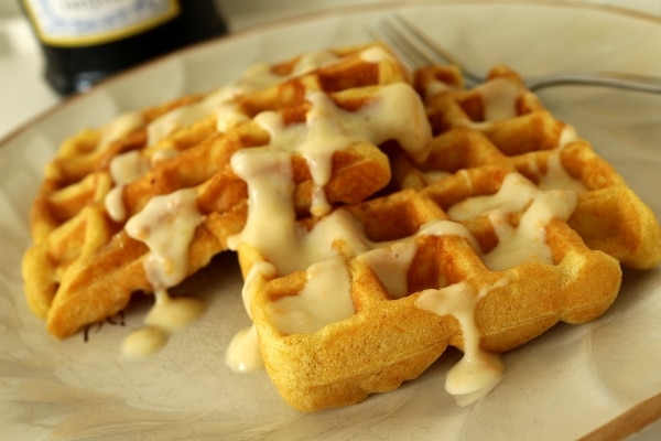 a closeup of two sour cream orange waffles on a plate