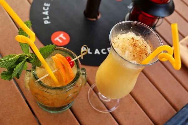 overhead view of two tropical drinks on a table