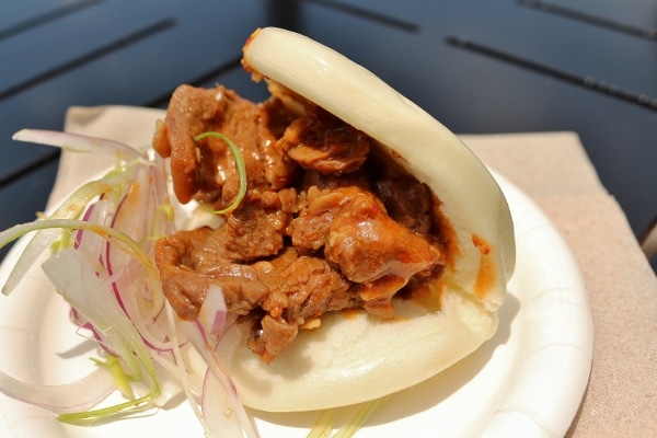 a steamed Asian bun filled with meat