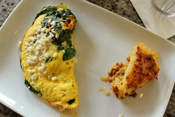 an omelet with a potato cake on the side