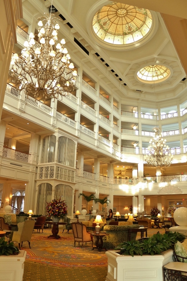 inside Disney\'s Grand Floridian Resort lobby with various sitting areas and large chandeliers