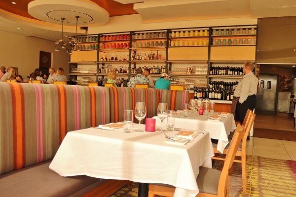 the interior of the California Grill dining room with the bar in the background