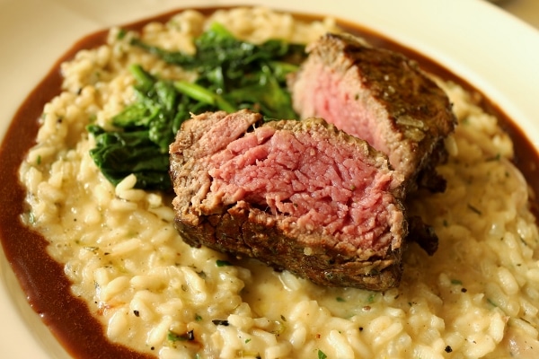 a piece of filet mignon steak cut to show the inside