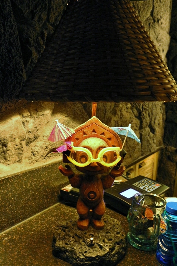 a tiki style lamp with goggles and drink umbrellas