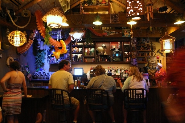 interior of a dark tiki bar with some nautical decorations