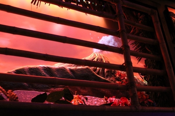 a closeup of an erupting volcano image behind bars