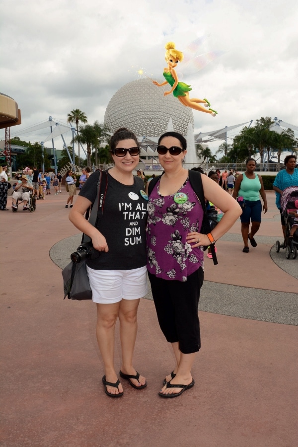 two women posing in front of Spaceship Earth at Epcot