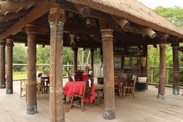 An outdoor covered area with tables and chairs underneath