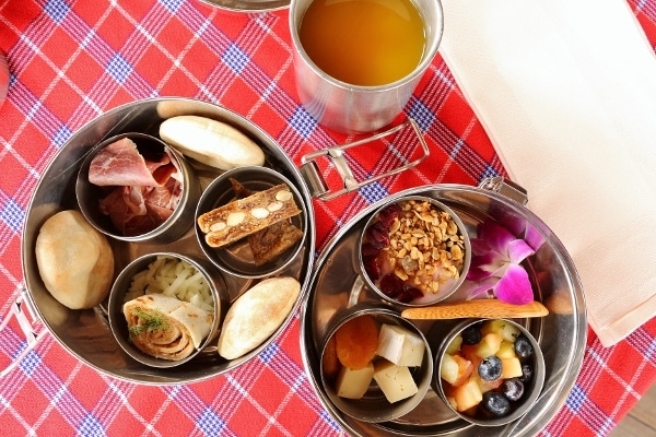 overhead view of small dishes of food on a checkered tablecloth