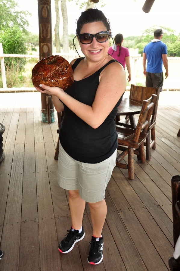 A woman holding a piece of varnished elephant poop