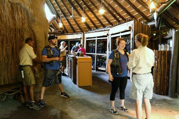 A group of people getting strapped into harnesses