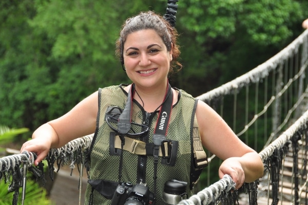 A woman posing on a rope bridge
