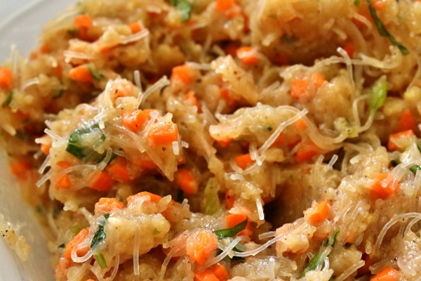 A close up of dumpling filling made with ground chicken, carrots, basil, and bean thread noodles