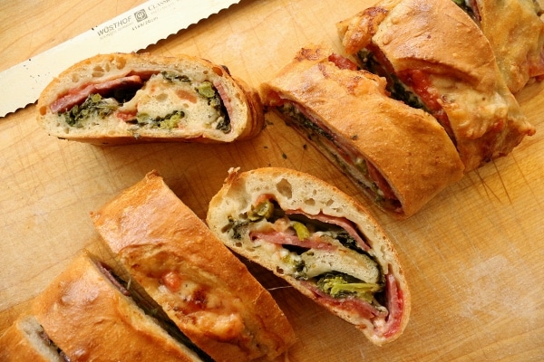 overhead view of several slices of stromboli on a wooden board