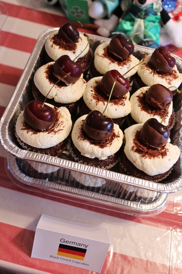 chocolate cupcakes garnished with chocolate-dipped cherries