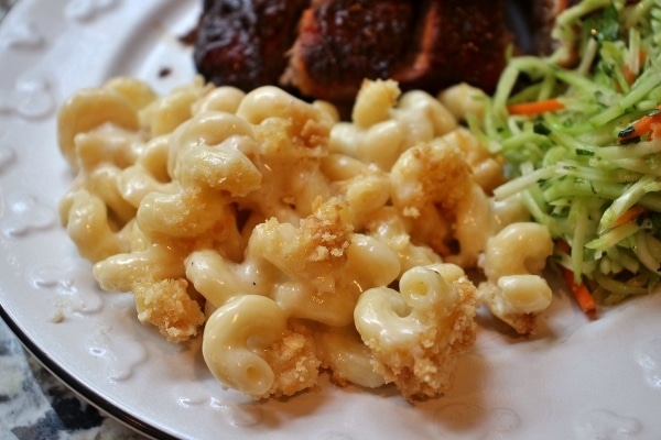 closeup of baked macaroni and cheese with ribs in the background