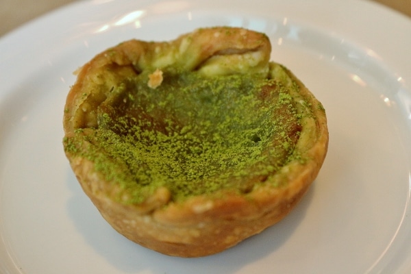 a small tart dusted with green matcha tea