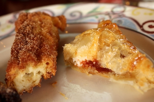 closeup of a couple half-eaten pastries on a plate