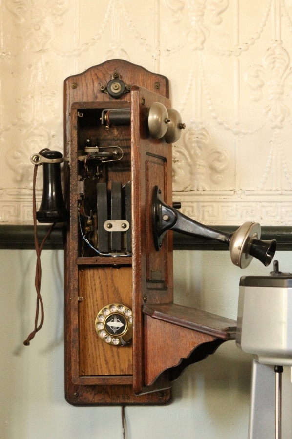 the inside of an old telephone on a wall