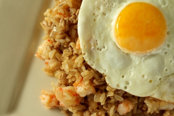 overhead view of fried rice with shrimp topped with a fried egg