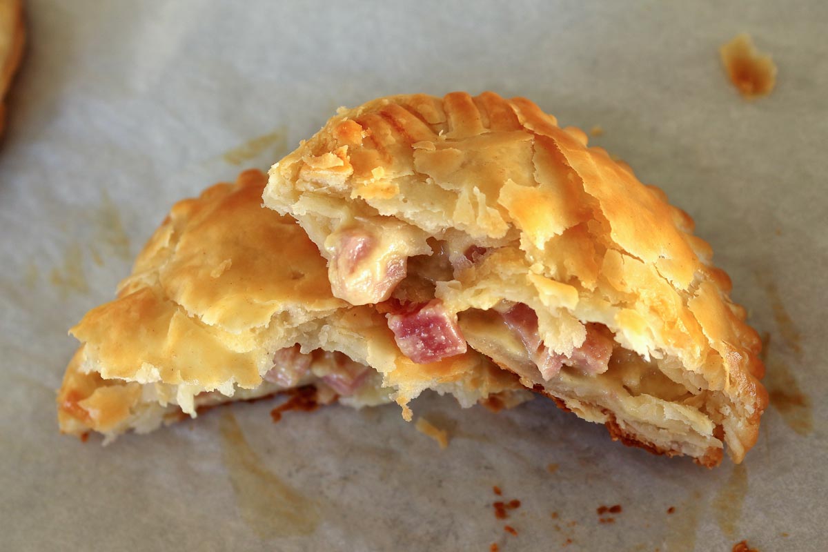 A round empanada broken in half with one half piled on top of the other.