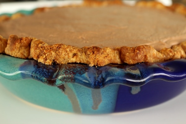 side view of a pie in a two-toned blue pie dish