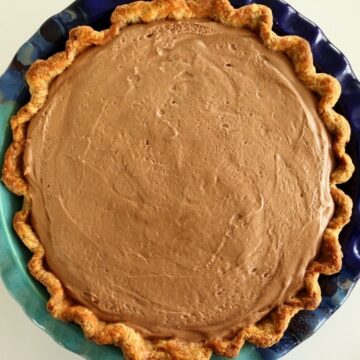 overhead view of a creamy Nutella pie in a blue pie dish