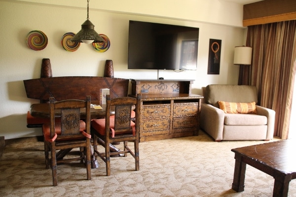 a dining area, television and chair in a hotel room