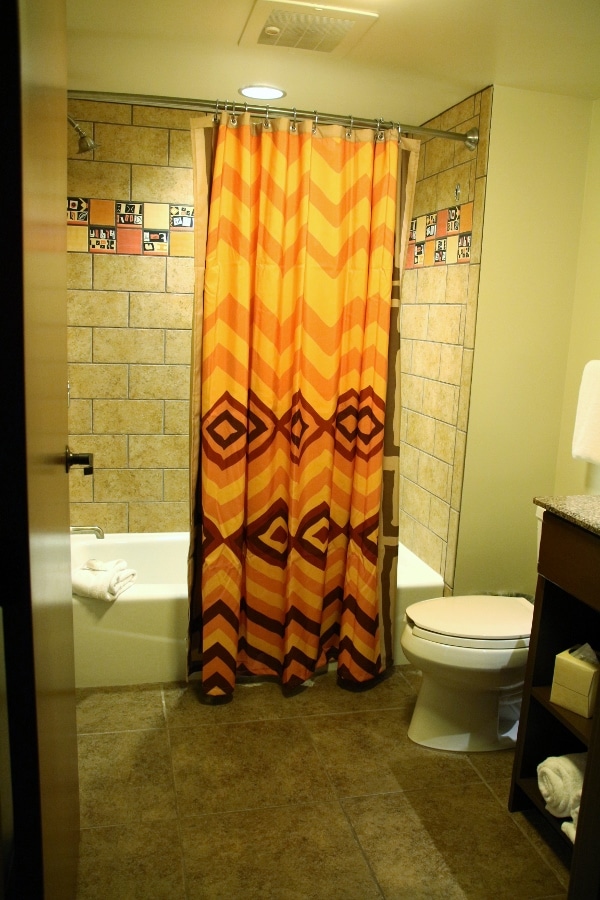 a bathroom with a colorful shower curtain