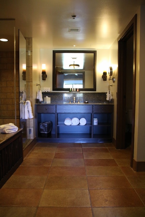 view into a bathroom with a large sink and mirror straight ahead