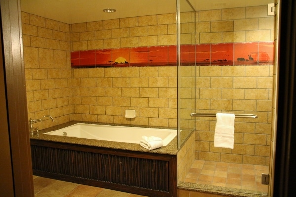wide view of a bathtub next to a large glass shower