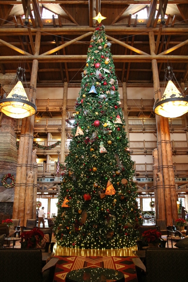 a tall view of the large Christmas tree in the Wilderness Lodge lobby