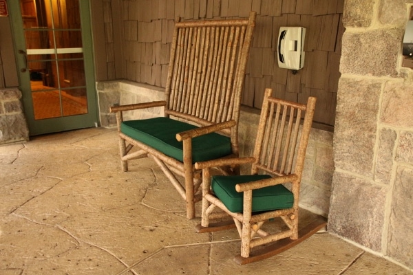 two rustic-looking chairs outside a building