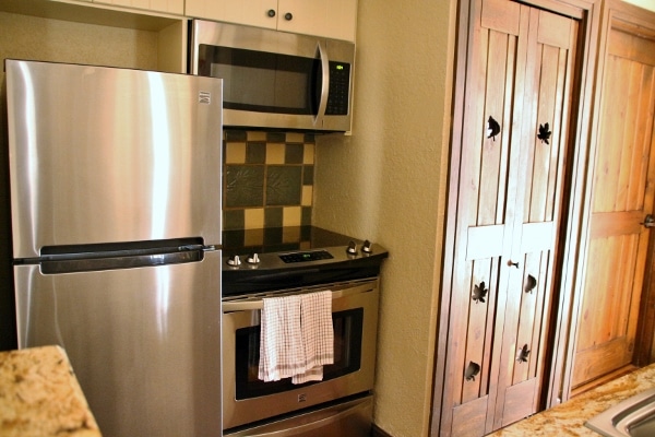 a stainless steel refrigerator and stove in a kitchen