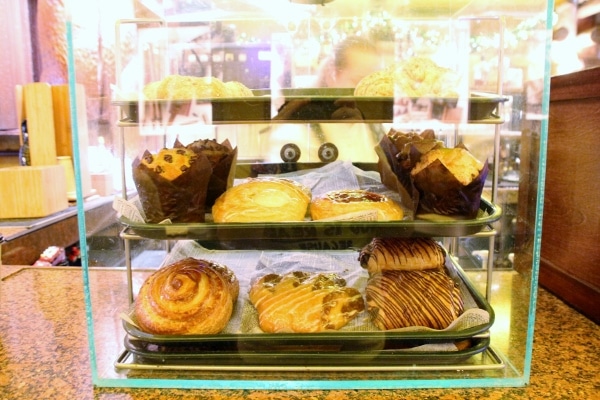 A glass display case with breakfast pastries