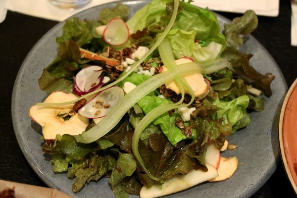 a salad on a blue plate