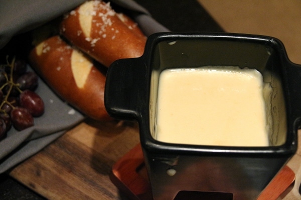 closeup of cheese fondue in a small black fondue dish
