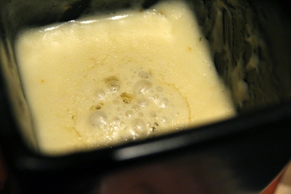 A close up of a bubbling dish of cheese fondue