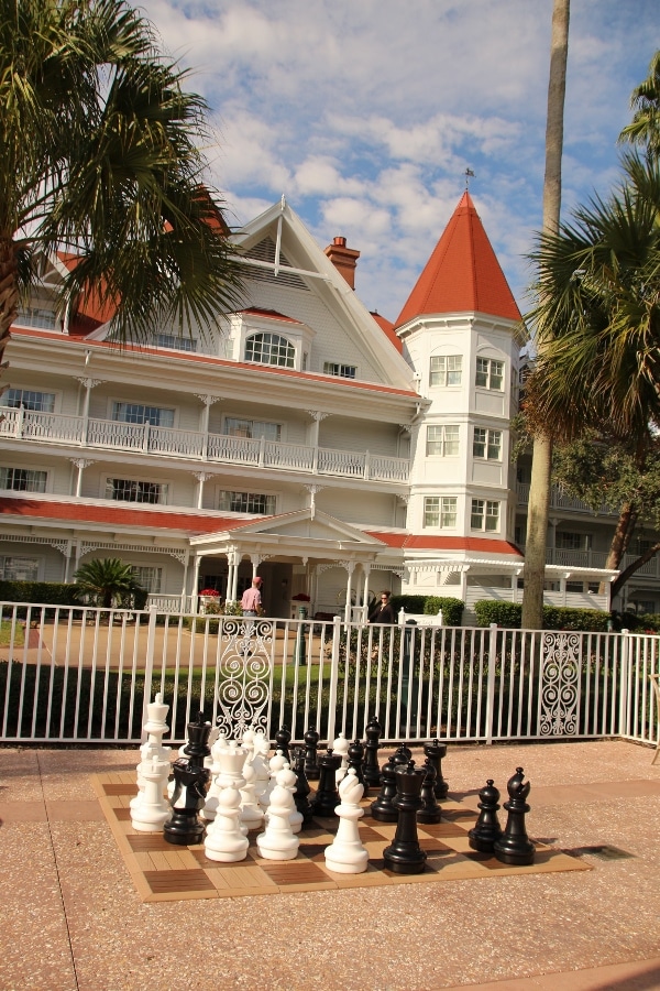 a large chess set built into the ground, in front of a large building