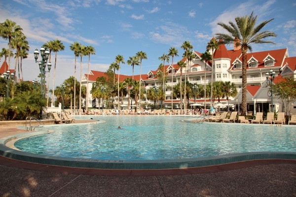 a peaceful swimming pool surrounded by tall palm trees