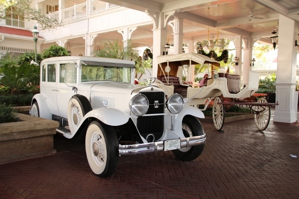 two white antique cars outside Disney\'s Grand Floridian Resort