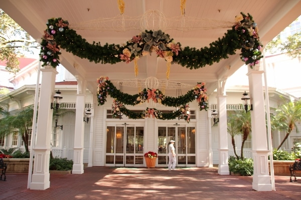 entrance to Disney\'s Grand Floridian Resort with floral garlands hanging above