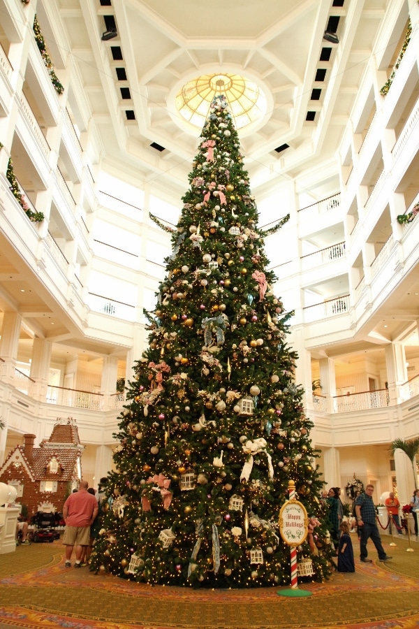 a large Christmas tree inside a hotel lobby