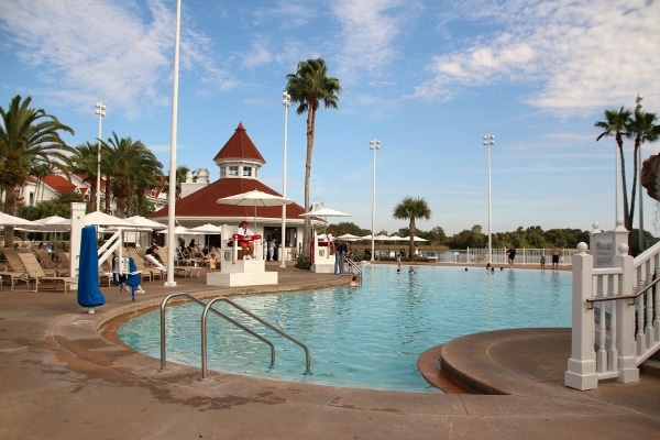 a swimming pool with palm trees nearby