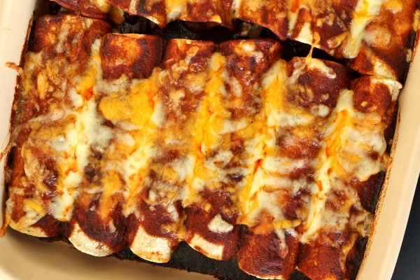 overhead view of a casserole of enchiladas with bubbly cheese