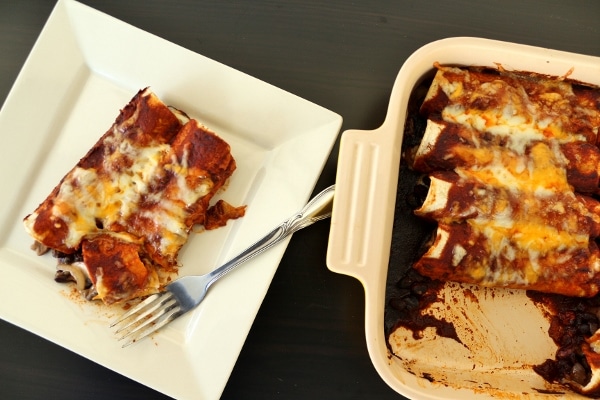 overhead view of a serving of enchiladas with red sauce and melted cheese