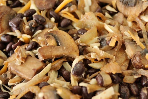 closeup of mushroom, black bean, onion, and cheese filling in a bowl