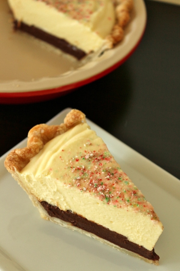 a slice of pie with a chocolate custard layer topped with peppermint mousse